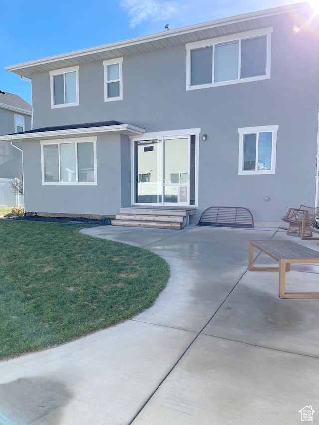 63 E Rose Way, Vineyard, UT 84059 - rear view of property with stucco siding, a patio, a lawn, and entry steps