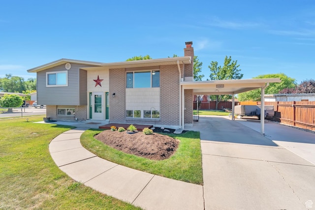 1241 W 4505 S, Taylorsville, UT 84123 - bi-level home with concrete driveway, a chimney, brick siding, and an attached carport