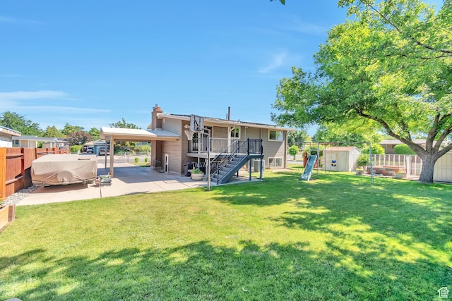 1241 W 4505 S, Taylorsville, UT 84123 - rear view of property with a shed, a patio area, stairs, and a fenced backyard