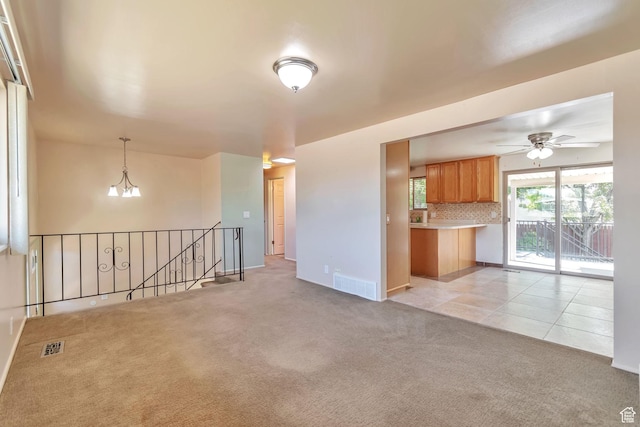 1241 W 4505 S, Taylorsville, UT 84123 - unfurnished living room featuring light carpet, ceiling fan, and light tile patterned flooring