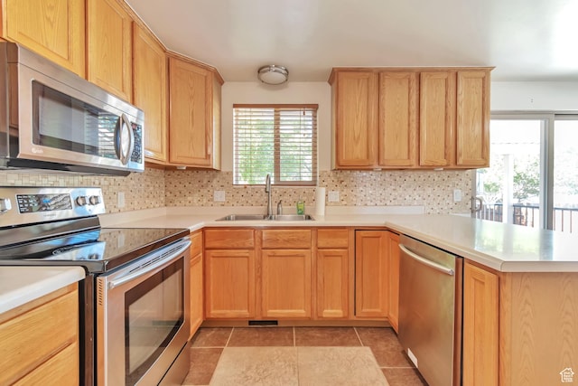 1241 W 4505 S, Taylorsville, UT 84123 - kitchen with stainless steel appliances, a peninsula, light countertops, and tasteful backsplash
