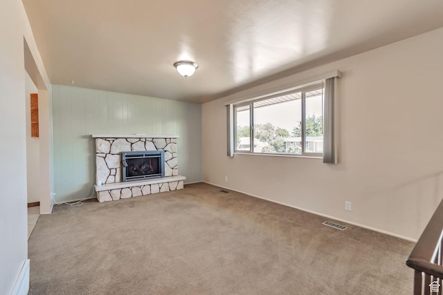 1241 W 4505 S, Taylorsville, UT 84123 - unfurnished living room with carpet, a stone fireplace, and baseboard heating
