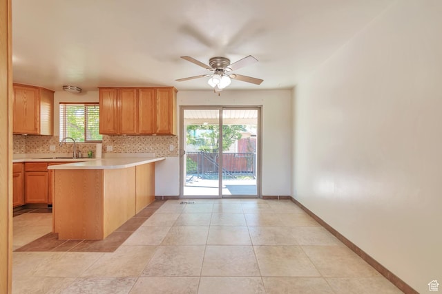 1241 W 4505 S, Taylorsville, UT 84123 - kitchen featuring a peninsula, light countertops, decorative backsplash, ceiling fan, and light tile patterned floors