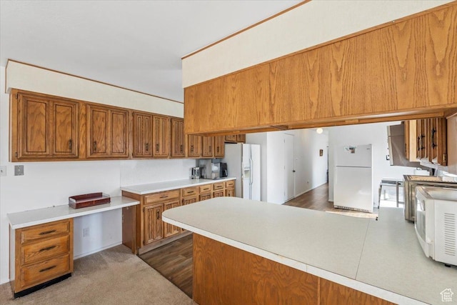 1252 N 100 E, American Fork, UT 84003 - kitchen featuring freestanding refrigerator, brown cabinetry, white refrigerator with ice dispenser, a peninsula, and light countertops