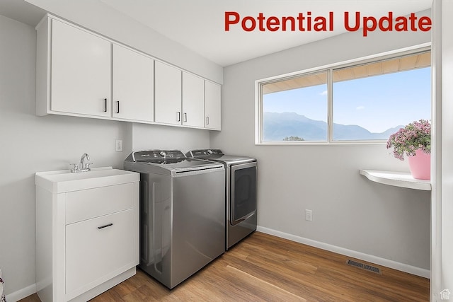 1252 N 100 E, American Fork, UT 84003 - laundry area featuring washing machine and dryer, cabinet space, wood finished floors, and a mountain view