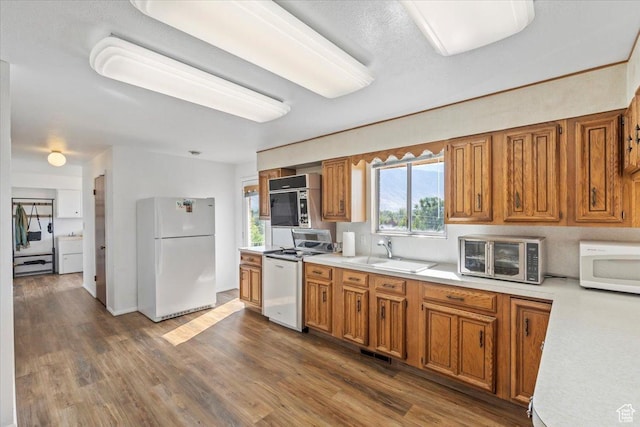 1252 N 100 E, American Fork, UT 84003 - kitchen featuring white appliances, light countertops, brown cabinets, washer / clothes dryer, and dark wood-style floors