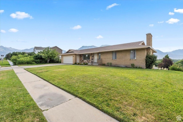1252 N 100 E, American Fork, UT 84003 - ranch-style house featuring an attached garage, a mountain view, a chimney, brick siding, and a front lawn