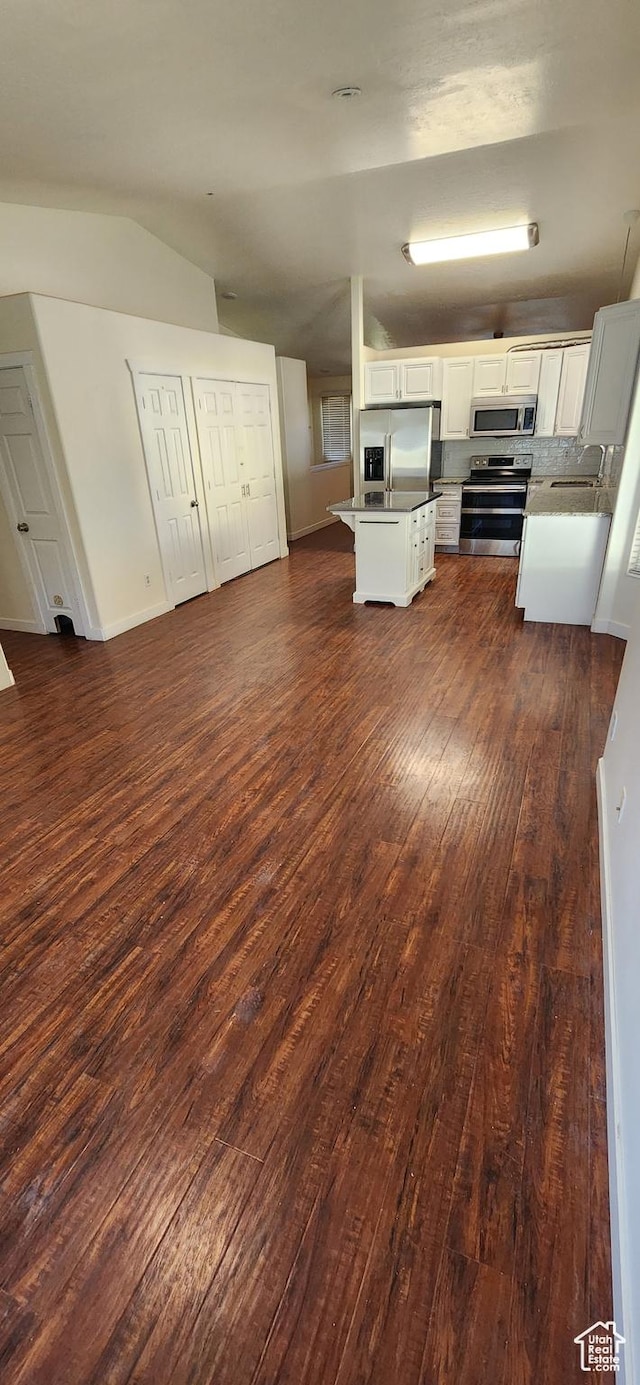 747 W 1580 N, Clinton, UT 84015 - kitchen featuring stainless steel appliances, open floor plan, dark wood-style floors, lofted ceiling, and white cabinets