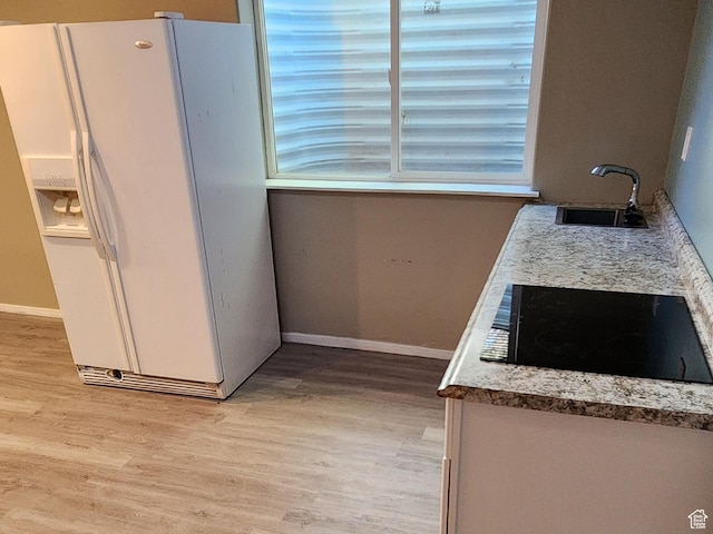 747 W 1580 N, Clinton, UT 84015 - kitchen featuring white fridge with ice dispenser, black electric stovetop, light wood-style floors, and white cabinets