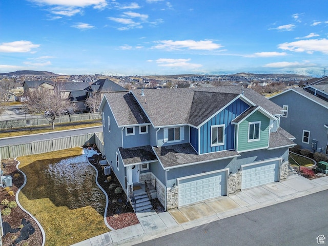 3323 E Gibraltar Ave, Eagle Mountain, UT 84005 - view of front of house with a garage, stucco siding, stone siding, board and batten siding, and a residential view