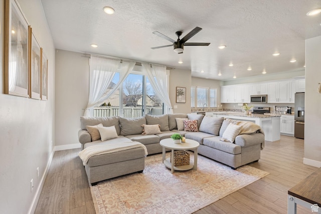 3323 E Gibraltar Ave, Eagle Mountain, UT 84005 - living area with a ceiling fan, light wood-style floors, a textured ceiling, and recessed lighting