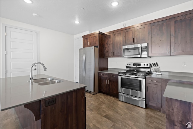 5160 W Villas N Dr N Unit 6-102, Hurricane, UT 84737 - kitchen featuring appliances with stainless steel finishes, dark brown cabinets, recessed lighting, and a kitchen bar