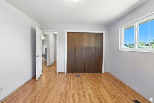 735 E 100 S, Hyrum, UT 84319 - unfurnished bedroom with light wood-style floors and a closet
