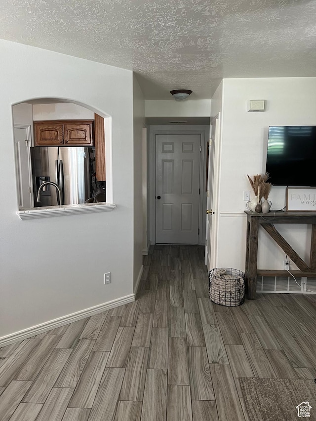 798 W Norway Maple Ct, Payson, UT 84651 - hall featuring wood finished floors, a textured ceiling, and arched walkways
