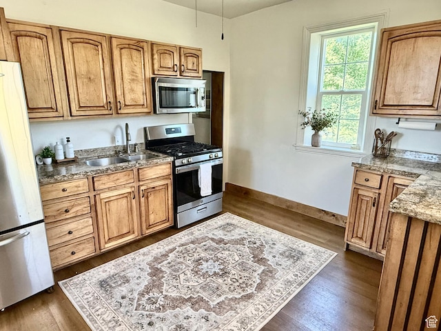 302 W 80 N, Moroni, UT 84646 - kitchen with appliances with stainless steel finishes, dark wood-type flooring, and brown cabinets
