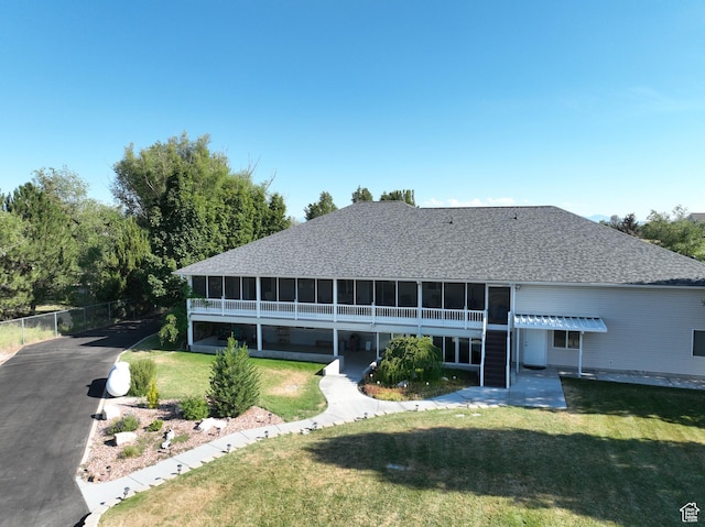5160 W 5725 S, Hooper, UT 84315 - back of property featuring a sunroom, roof with shingles, and asphalt driveway