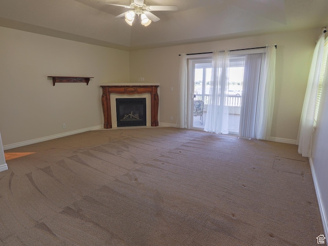 5160 W 5725 S, Hooper, UT 84315 - unfurnished living room featuring a glass covered fireplace, a ceiling fan, and carpet flooring
