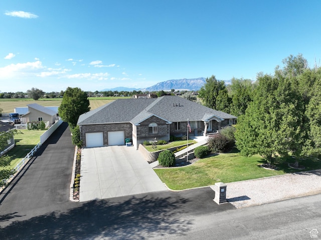 5160 W 5725 S, Hooper, UT 84315 - view of front of home featuring an attached garage, concrete driveway, a mountain view, a front yard, and a shingled roof