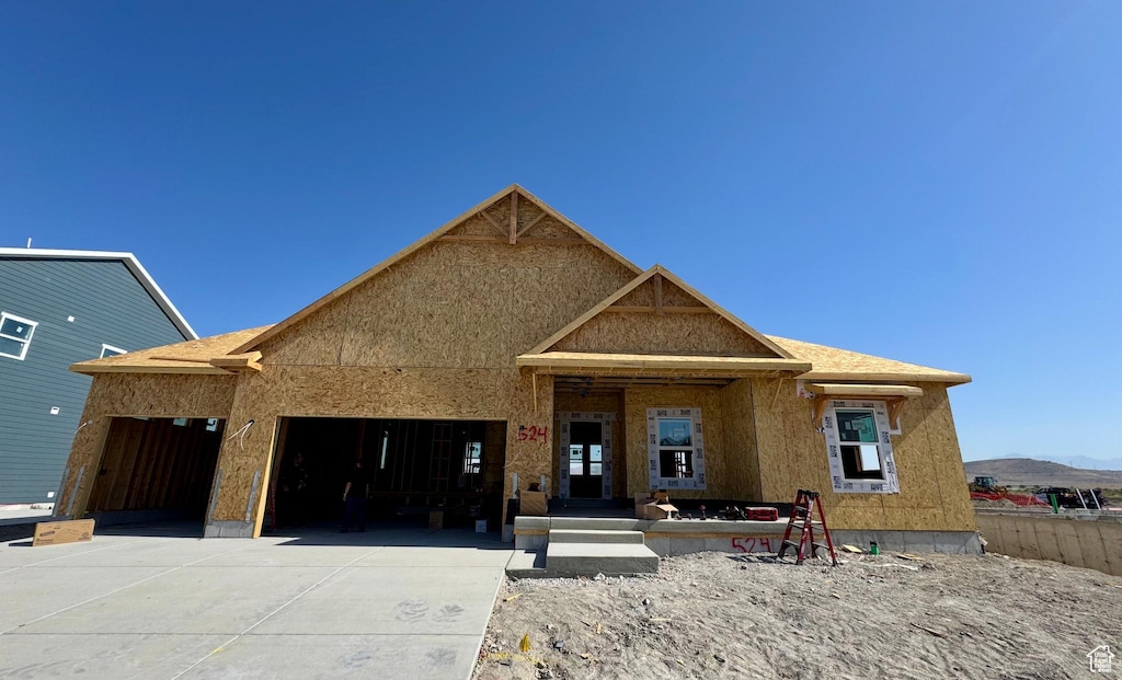 1187 E Blackfeet Dr Unit 524, Eagle Mountain, UT 84005 - view of front of property with concrete driveway, a garage, and a mountain view