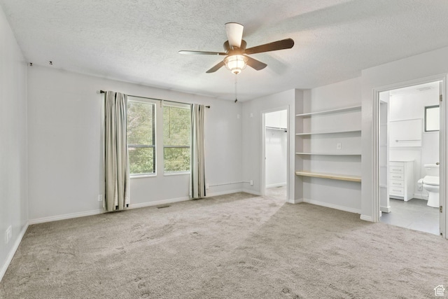 235 E 7615 S, Midvale, UT 84047 - unfurnished bedroom with a textured ceiling, carpet floors, a spacious closet, ensuite bath, and a ceiling fan