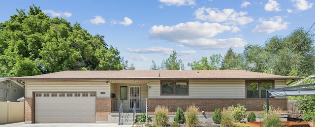 235 E 7615 S, Midvale, UT 84047 - view of front of home with brick siding, an attached garage, and concrete driveway