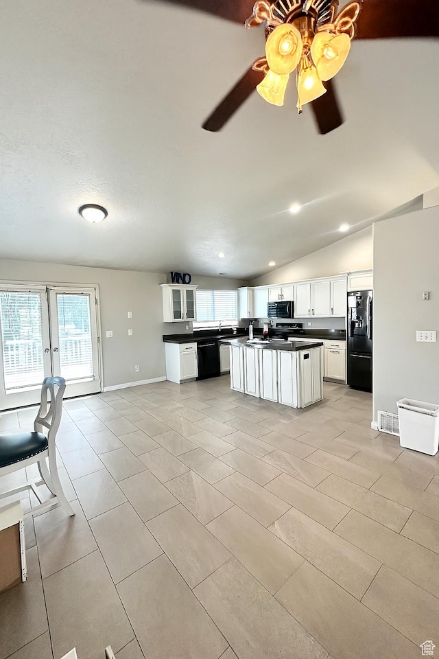 2879 S Fetzer Dr W, Magna, UT 84044 - kitchen featuring black appliances, dark countertops, white cabinets, ceiling fan, and vaulted ceiling