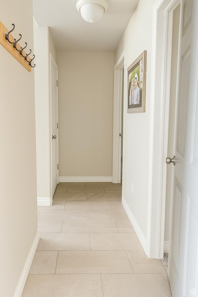 2879 S Fetzer Dr W, Magna, UT 84044 - corridor featuring light tile patterned floors and baseboards
