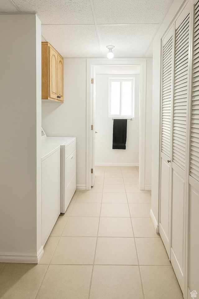 2879 S Fetzer Dr W, Magna, UT 84044 - laundry area featuring cabinet space, washer and clothes dryer, and light tile patterned flooring