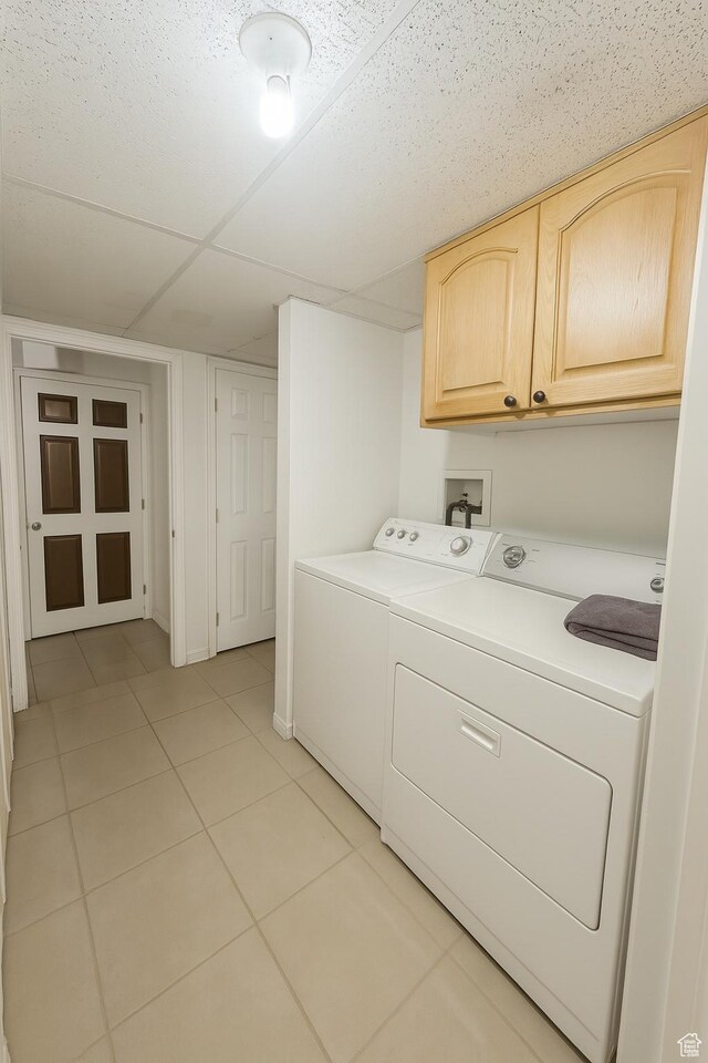 2879 S Fetzer Dr W, Magna, UT 84044 - laundry area featuring cabinet space, washing machine and clothes dryer, and light tile patterned floors