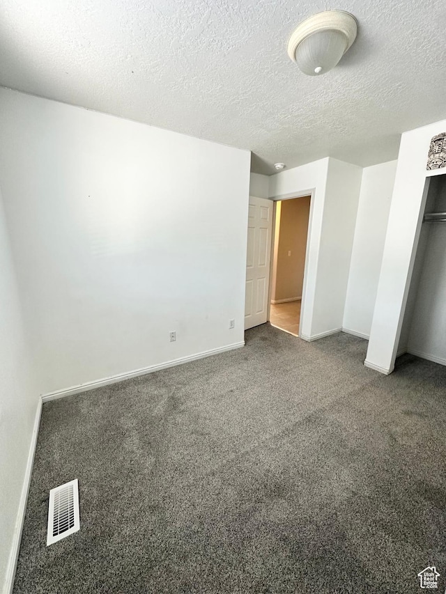 2879 S Fetzer Dr W, Magna, UT 84044 - unfurnished bedroom featuring carpet flooring, a textured ceiling, and a closet