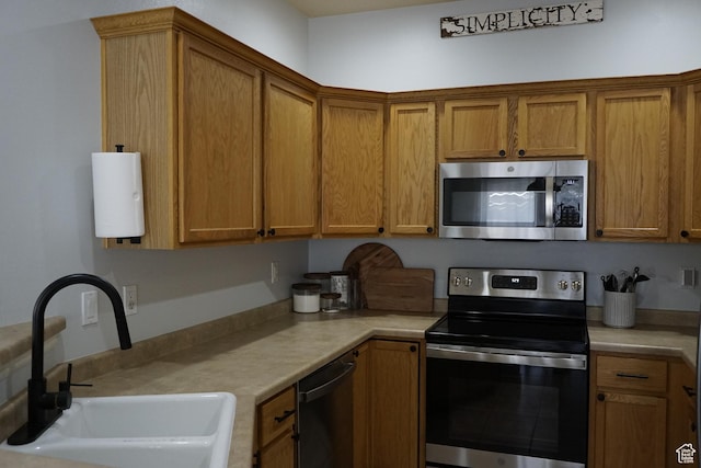 14072 S Julien Cv, Bluffdale, UT 84065 - kitchen featuring stainless steel appliances, light countertops, and brown cabinets