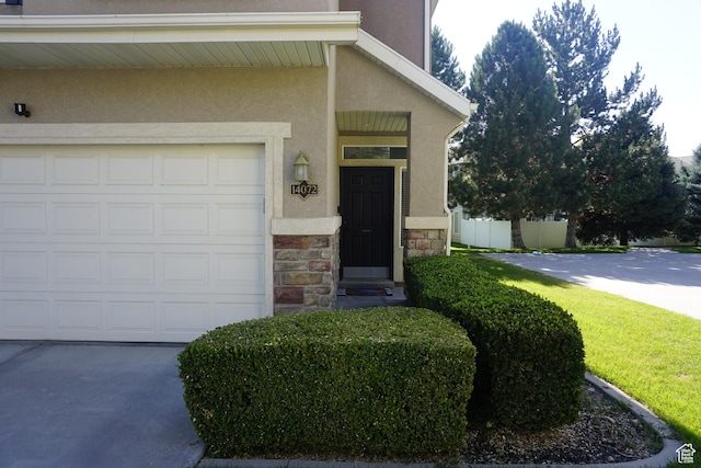 14072 S Julien Cv, Bluffdale, UT 84065 - view of exterior entry featuring stone siding, stucco siding, and concrete driveway