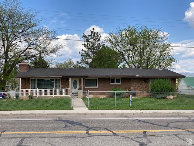 30 N Main St, Aurora, UT 84620 - single story home with stone siding, a chimney, and a fenced front yard