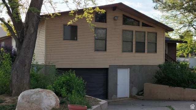 30 N Main St, Aurora, UT 84620 - view of front of home with an attached garage, driveway, and stucco siding