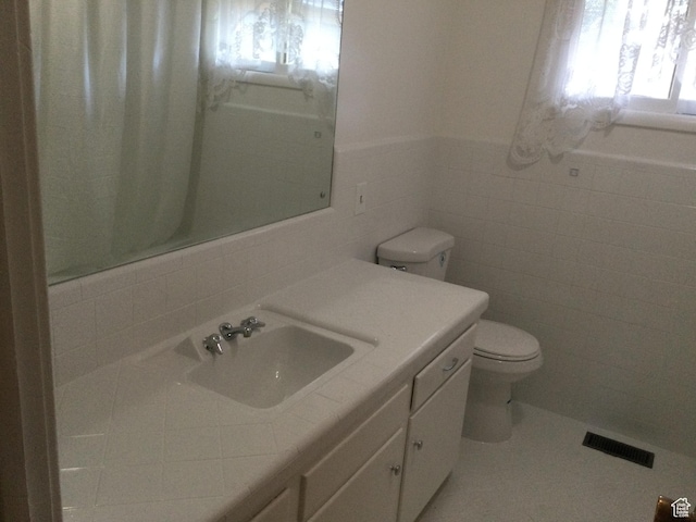 30 N Main St, Aurora, UT 84620 - bathroom with tile walls, vanity, and tile patterned floors