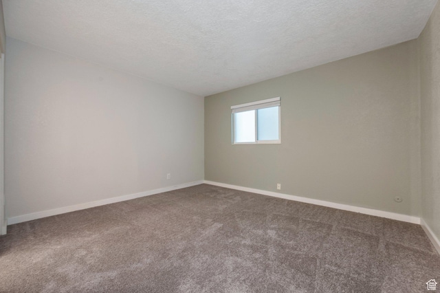 588 E Vine St S Unit 2C, Murray, UT 84107 - spare room with carpet flooring and a textured ceiling