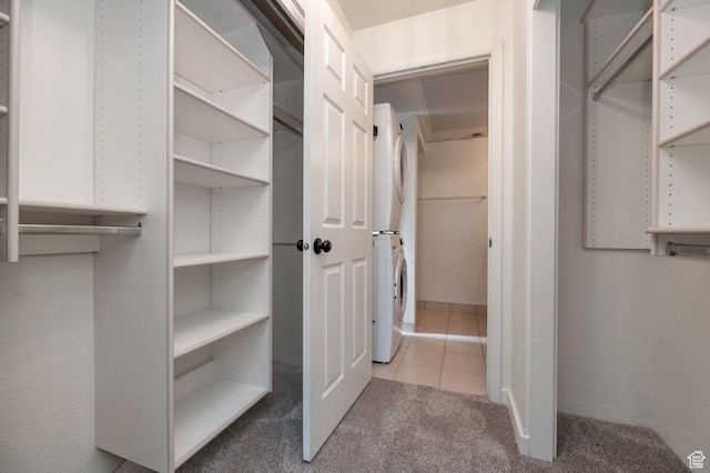 588 E Vine St S Unit 2C, Murray, UT 84107 - walk in closet with stacked washer / dryer, tile patterned flooring, and carpet floors