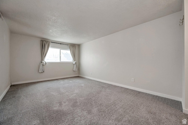 588 E Vine St S Unit 2C, Murray, UT 84107 - carpeted spare room with a textured ceiling and baseboards