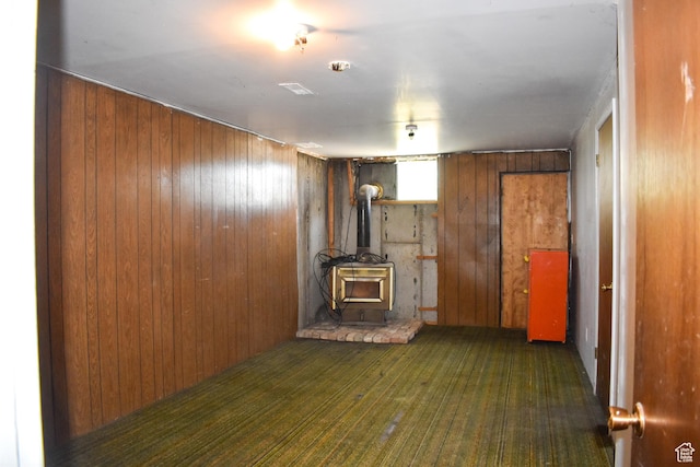 215 N Center St, Castle Dale, UT 84513 - unfurnished living room with a wood stove and wooden walls