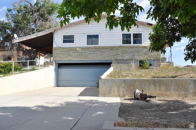215 N Center St, Castle Dale, UT 84513 - view of front facade featuring a garage and driveway