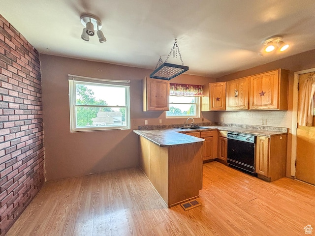 215 N Center St, Castle Dale, UT 84513 - kitchen with a peninsula, light wood-type flooring, brick wall, dishwasher, and dark countertops