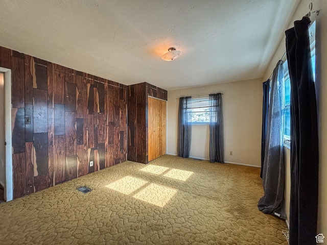 215 N Center St, Castle Dale, UT 84513 - carpeted empty room featuring wood walls