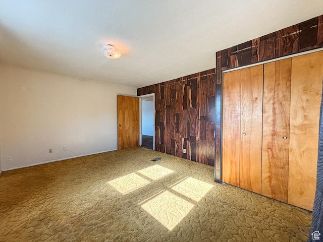 215 N Center St, Castle Dale, UT 84513 - unfurnished bedroom featuring wood walls and carpet floors