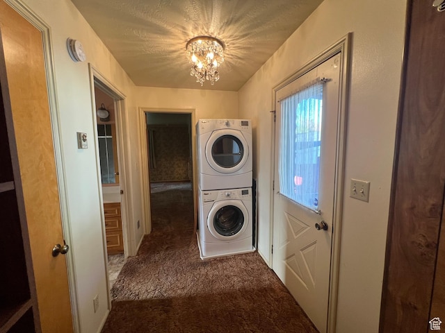 531 E 100 S, Logan, UT 84321 - laundry room featuring estacked washer and dryer, carpet, and a chandelier
