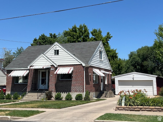 531 E 100 S, Logan, UT 84321 - bungalow-style home with an outdoor structure, entry steps, brick siding, a garage, and a shingled roof