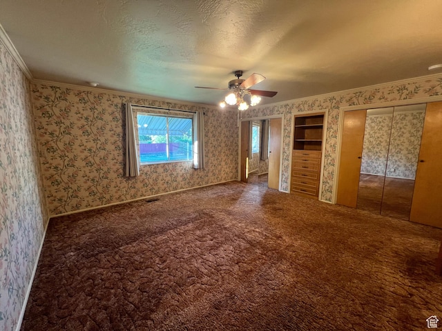 531 E 100 S, Logan, UT 84321 - unfurnished bedroom featuring wallpapered walls, ornamental molding, multiple closets, carpet floors, and a ceiling fan