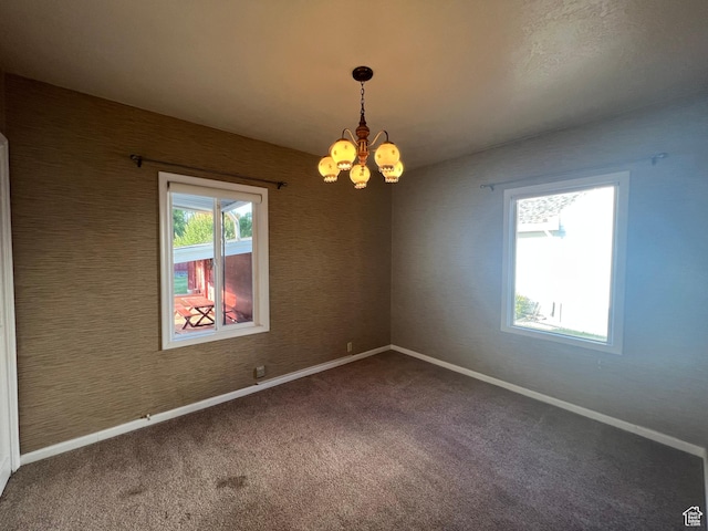 531 E 100 S, Logan, UT 84321 - empty room featuring a chandelier and carpet floors