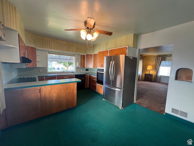 531 E 100 S, Logan, UT 84321 - kitchen with dark colored carpet, black appliances, a peninsula, a ceiling fan, and plenty of natural light