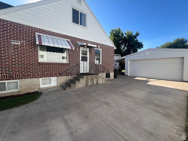 531 E 100 S, Logan, UT 84321 - view of side of property with a garage, an outdoor structure, and brick siding