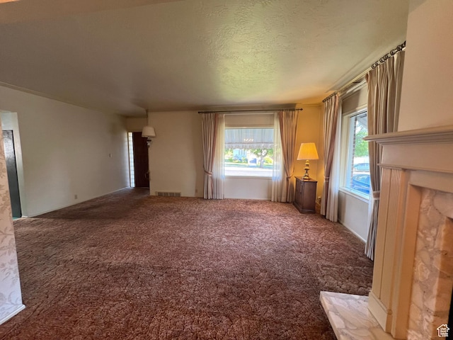 531 E 100 S, Logan, UT 84321 - unfurnished living room with carpet flooring and a textured ceiling